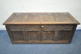 A GEORGIAN OAK PANELLED COFFER, with a hinged lid and carved details to the front, width 159cm x