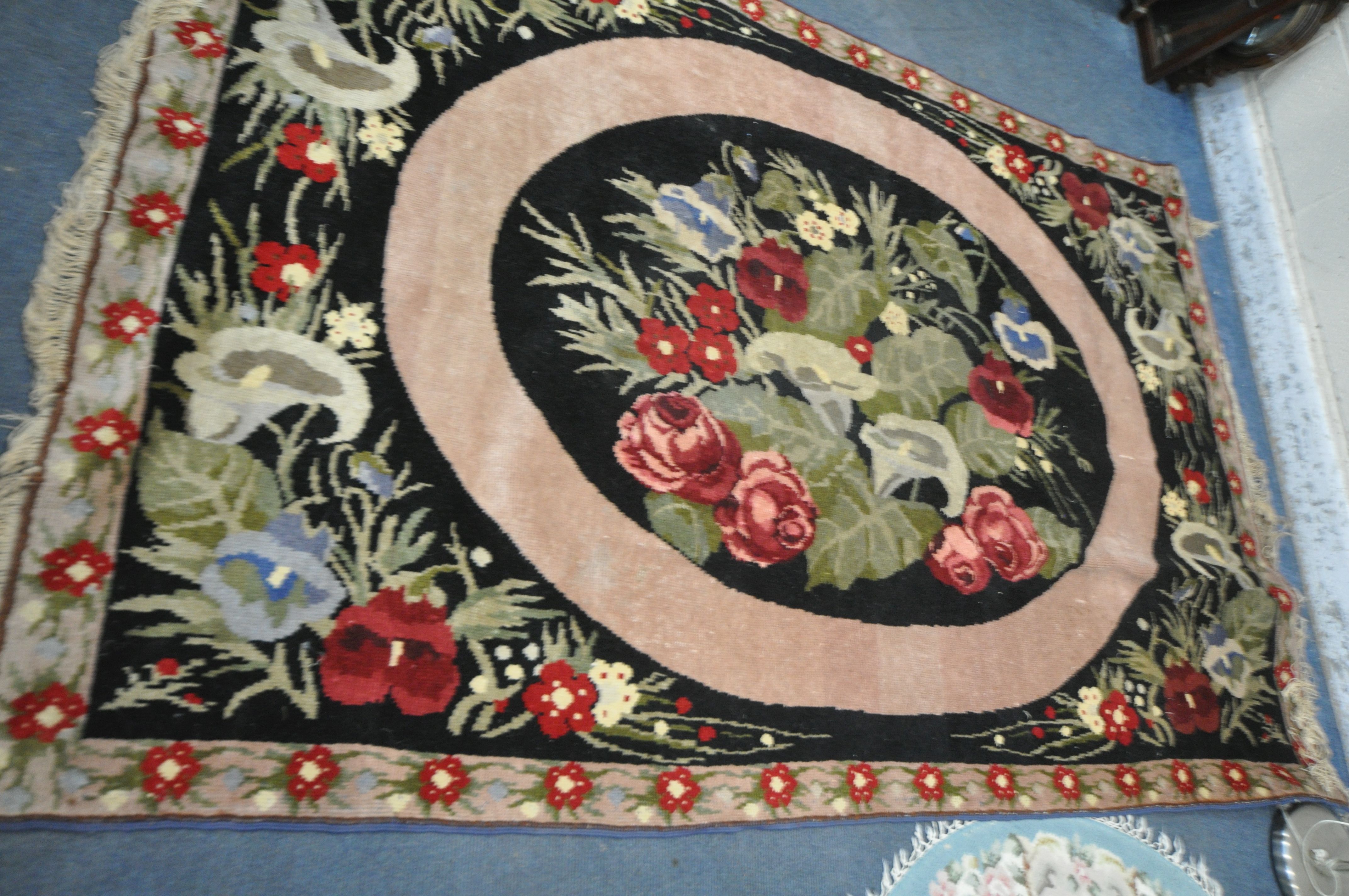 A WOOLLEN FLORAL RUG, on a black ground, 248cm x 168cm, along with a Chinese blue circular rug, - Image 2 of 4