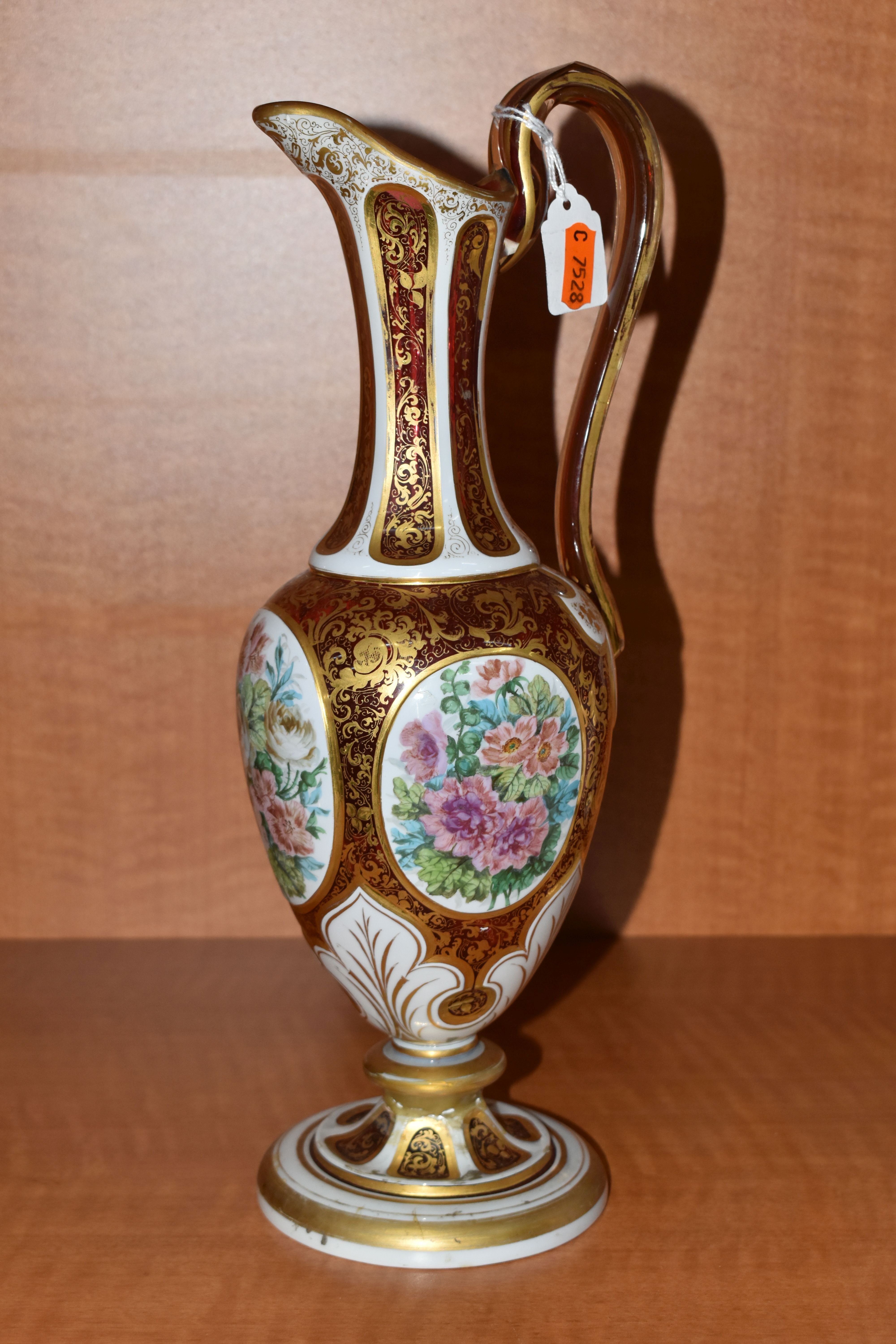 A SECOND HALF 19TH CENTURY CASED GLASS EWER, with 'S' scroll handle, the body overlaid with white