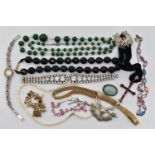 A BAG OF COSTUME JEWELLERY, two paste set white metal necklaces, a green beaded necklace, a mother