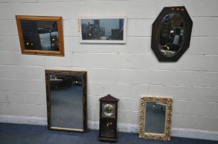 AN OAK OVAL WALL MIRROR, along with four other modern mirrors, a modern wall clock and two lamps (