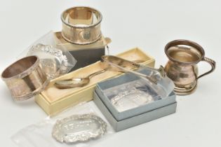 AN ASSORTMENT OF SILVER, to include two silver napkin rings, a miniature tankard, a pair of sugar