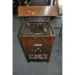 AN EARLY TO MID 20th CENTURY RADIOGRAM with a lidded walnut veneered cabinet, a Garrard 'Automatic