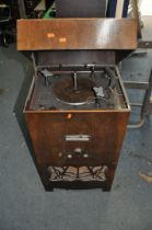 AN EARLY TO MID 20th CENTURY RADIOGRAM with a lidded walnut veneered cabinet, a Garrard 'Automatic