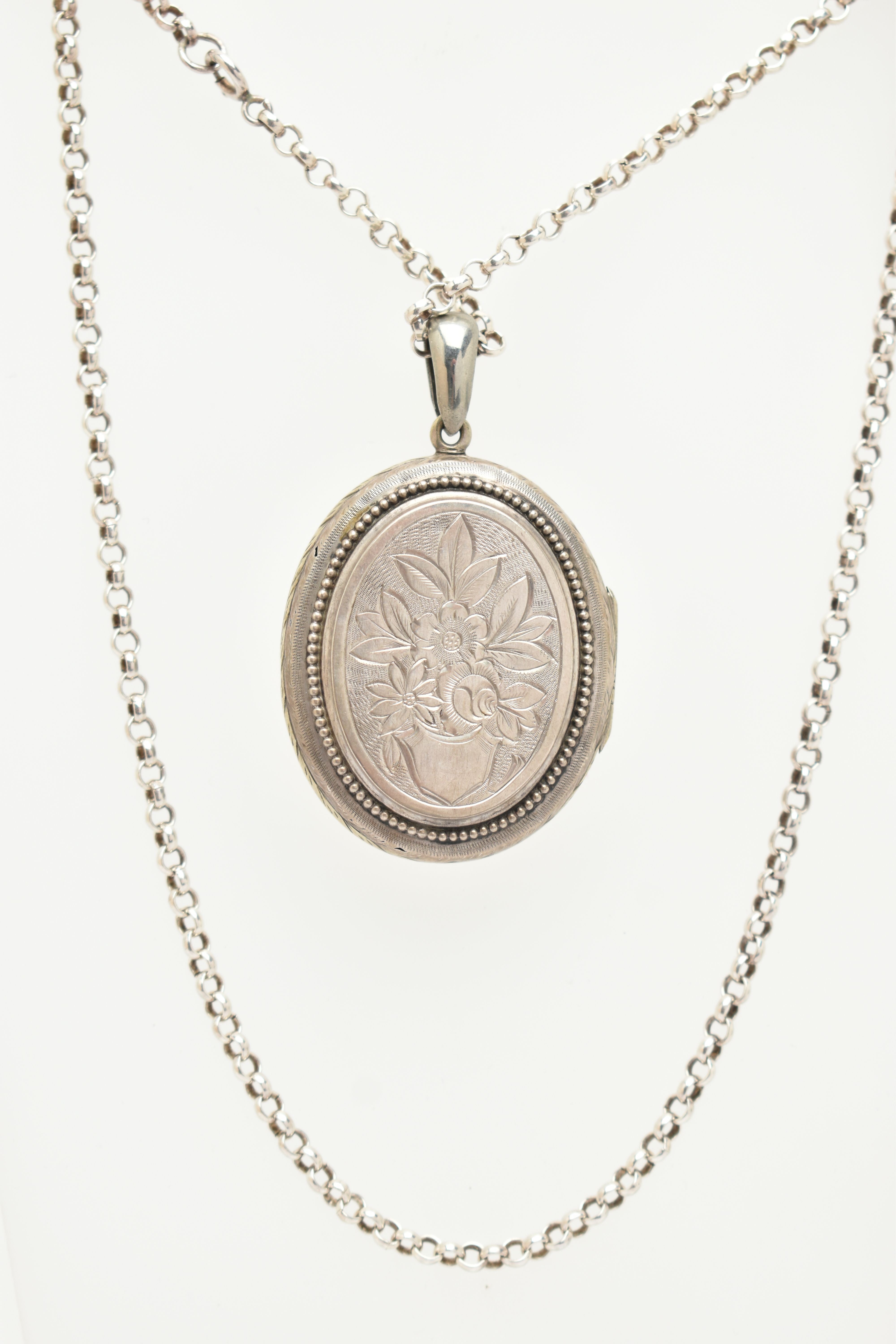A LOCKET AND A CHAIN, a base metal oval locket with embossed floral and acanthus detail, together - Image 2 of 3