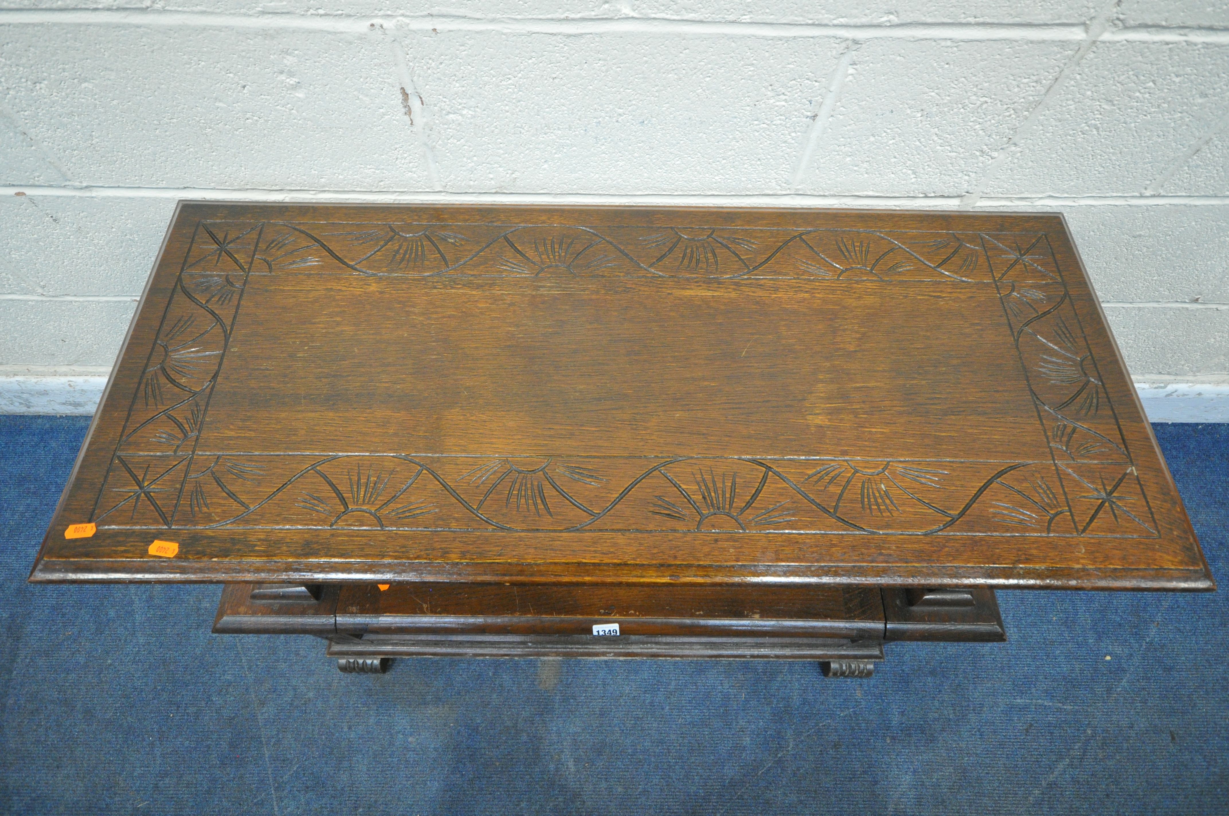 AN EARLY 20TH CENTURY OAK MONKS BENCH, with a rise and fall backrest / surface, lion armrests and - Image 2 of 4