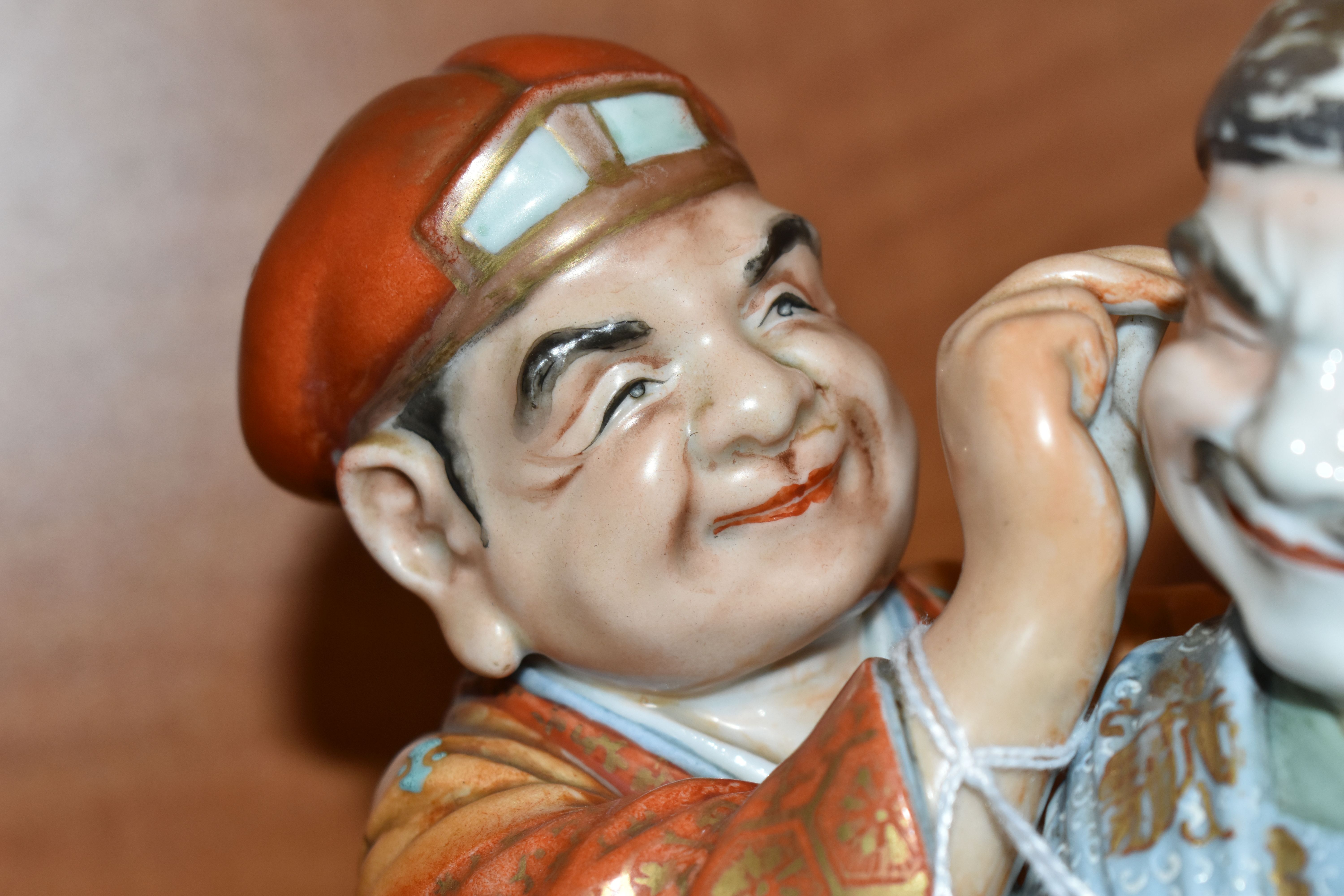 A LATE 19TH / EARLY 20TH CENTURY JAPANESE PORCELAIN FIGURE GROUP OF TWO MEN, one holding a carp - Image 6 of 9