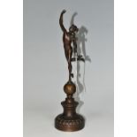 A SMALL BRONZED FIGURE OF HERMES, standing on top of a globe, on a socle base, unsigned, height 31cm