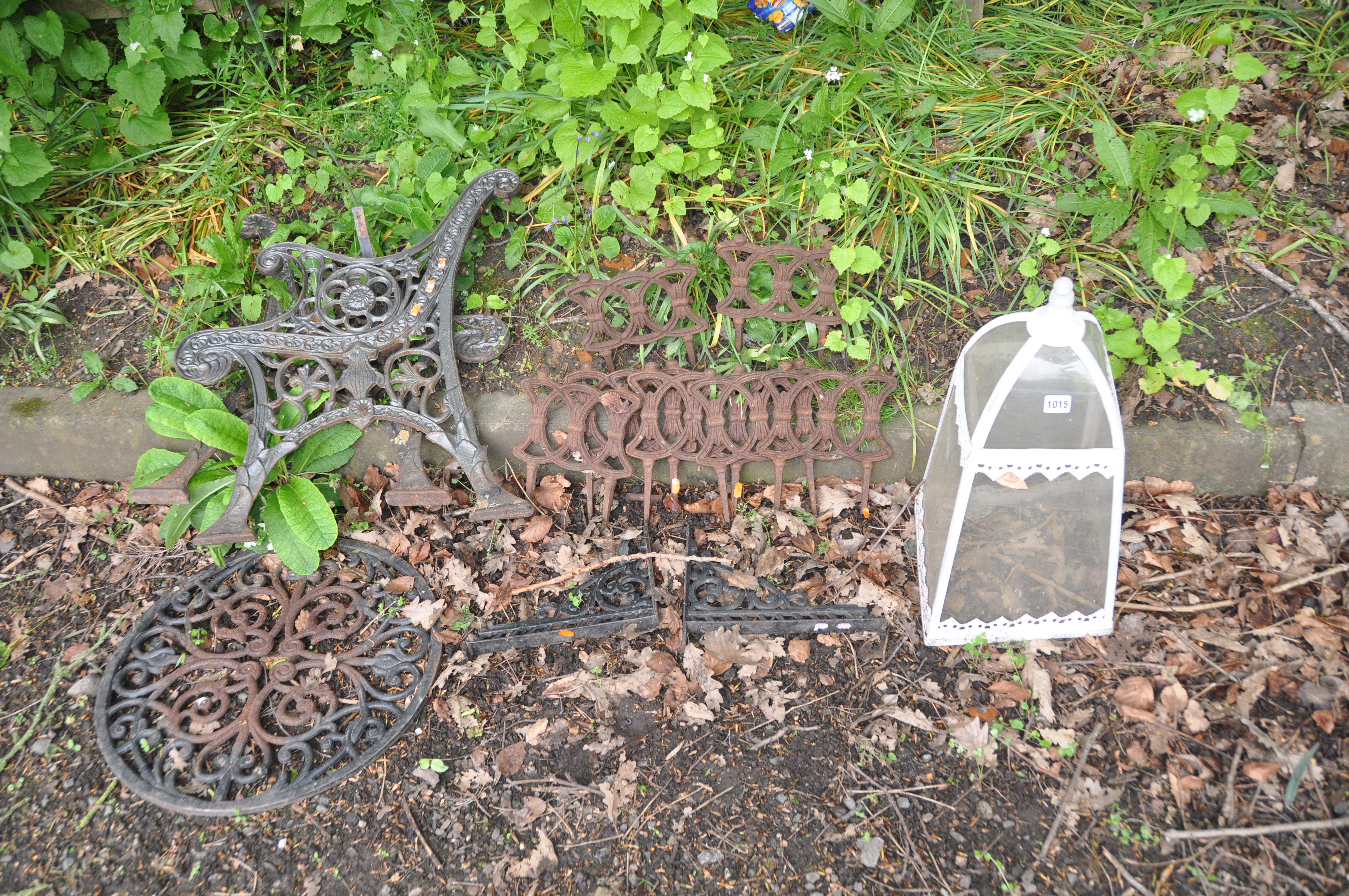 A COLLECTION OF CAST IRON GARDEN ITEMS including seven Victorian lawn edgers, a modern table top,