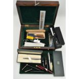 A WOODEN BOX WITH ASSORTED PENS, a hinged wooden box encasing a selection of fountain pens, names to