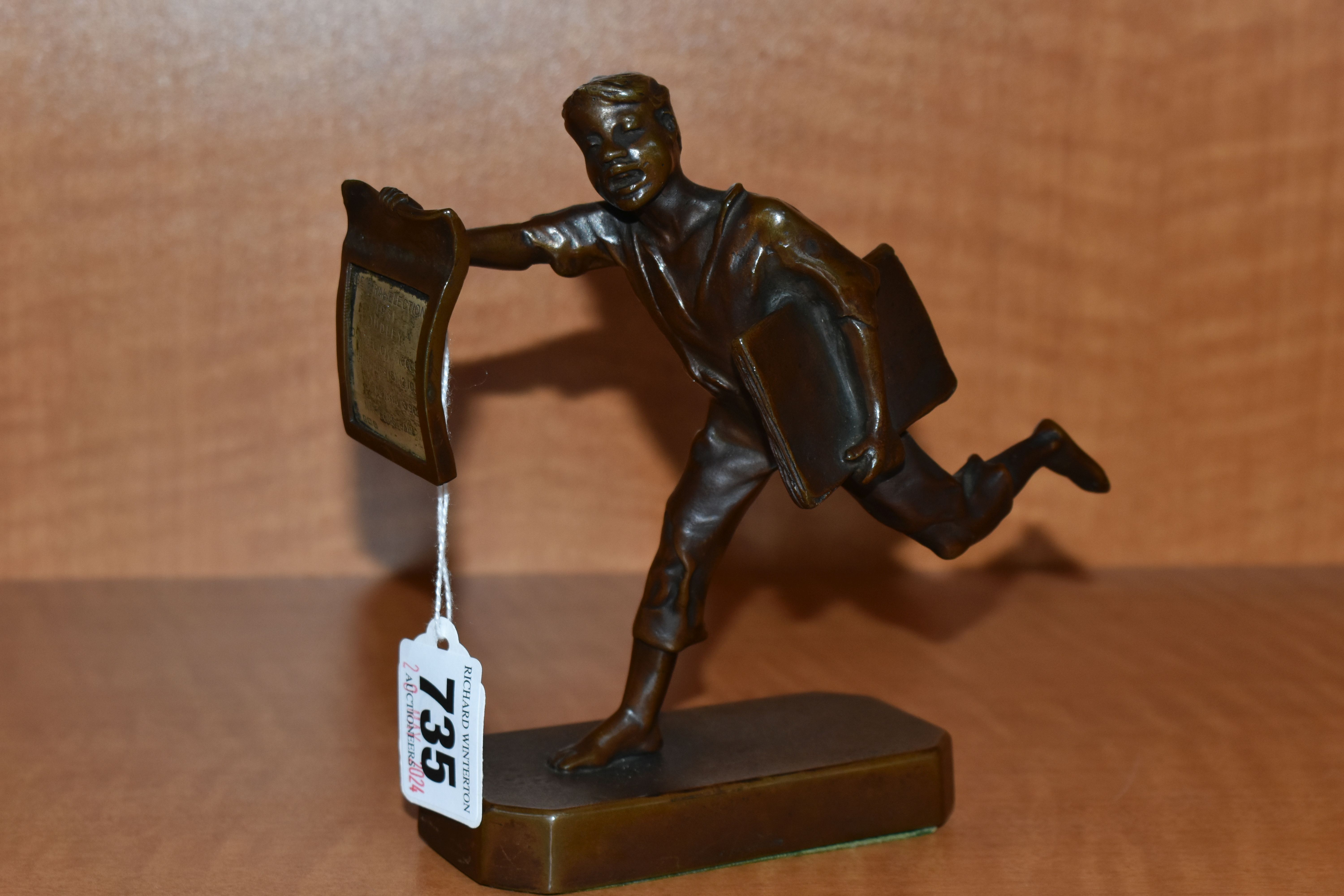 A 1930'S POLITAL INTEREST BRONZE FIGURE OF A BARE FOOTED NEWSPAPER BOY POSED AS RUNNING, with a