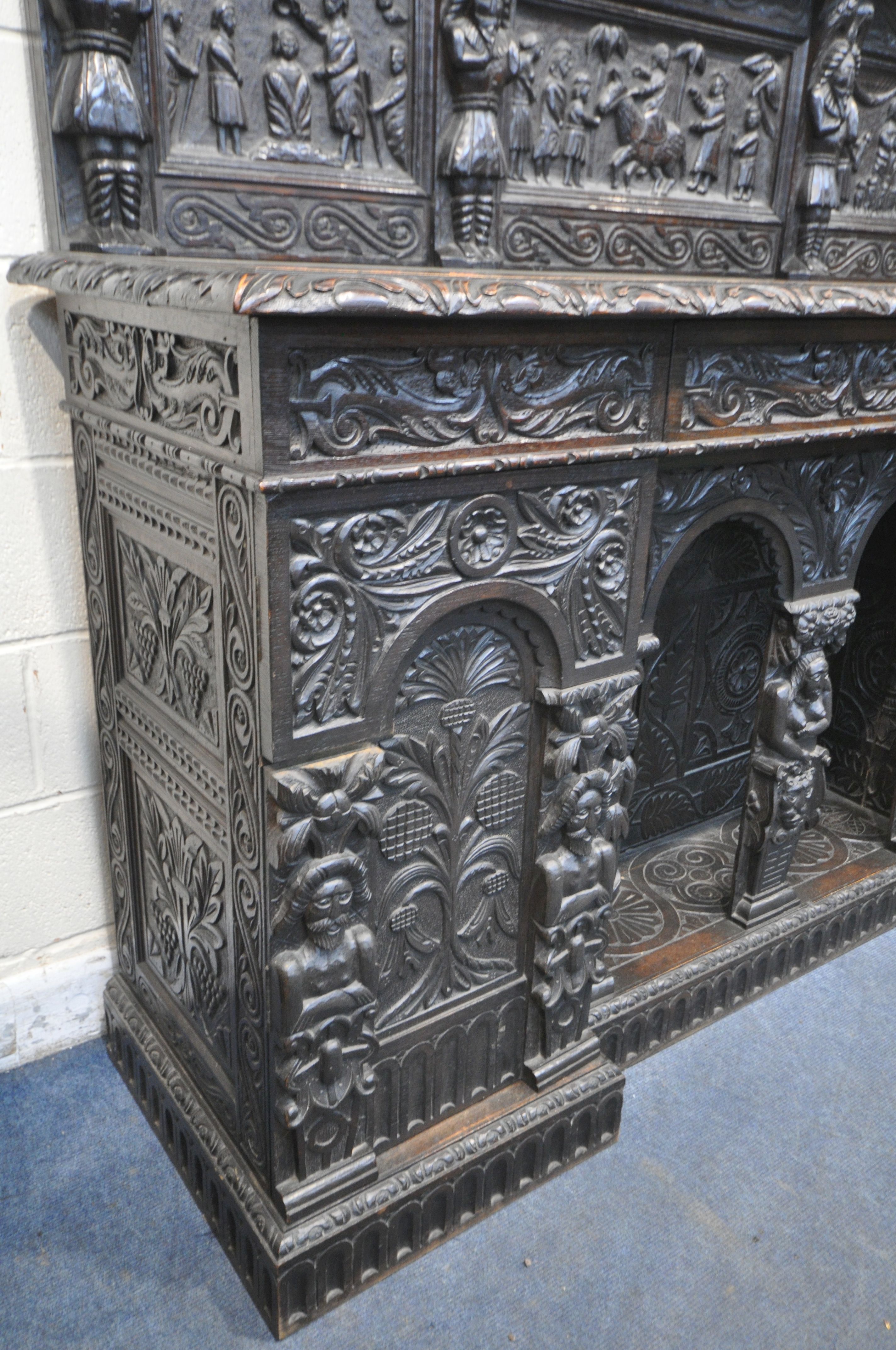 A 19TH CENTURY HEAVILY CARVED OAK SIDEBOARD, the raised back with panelling and shelf, fitted with - Image 4 of 10