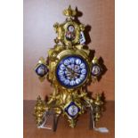 A LATE 19TH CENTURY GILT METAL AND PORCELAIN MOUNTED MANTEL CLOCK, the porcelain dial with Roman