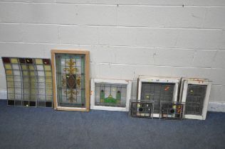 A SELECTION OF STAINED / COLOURED GLASS WINDOWS, to include a window with a Fleur De Lis design,