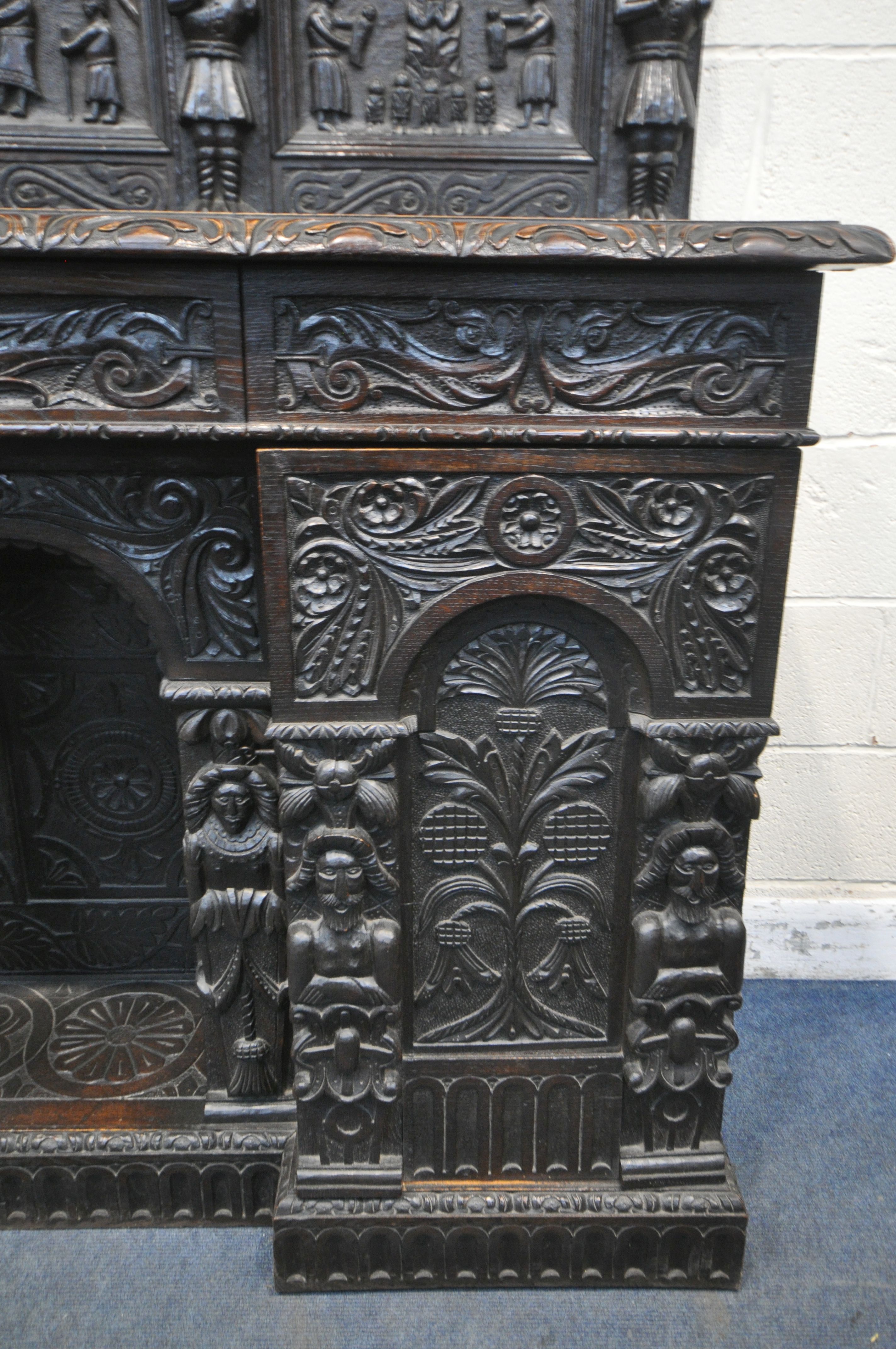 A 19TH CENTURY HEAVILY CARVED OAK SIDEBOARD, the raised back with panelling and shelf, fitted with - Image 7 of 10