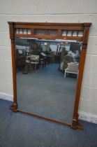 AN EDWARDIAN WALNUT OVERMANTEL MIRROR, with turned spindles and open fretwork, 110cm x 114cm (