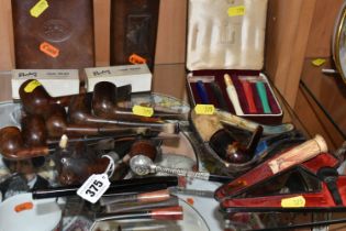 A COLLECTION OF TOBACCO PIPES AND CHEROOT HOLDERS, comprising two brown leather cigar cases, two