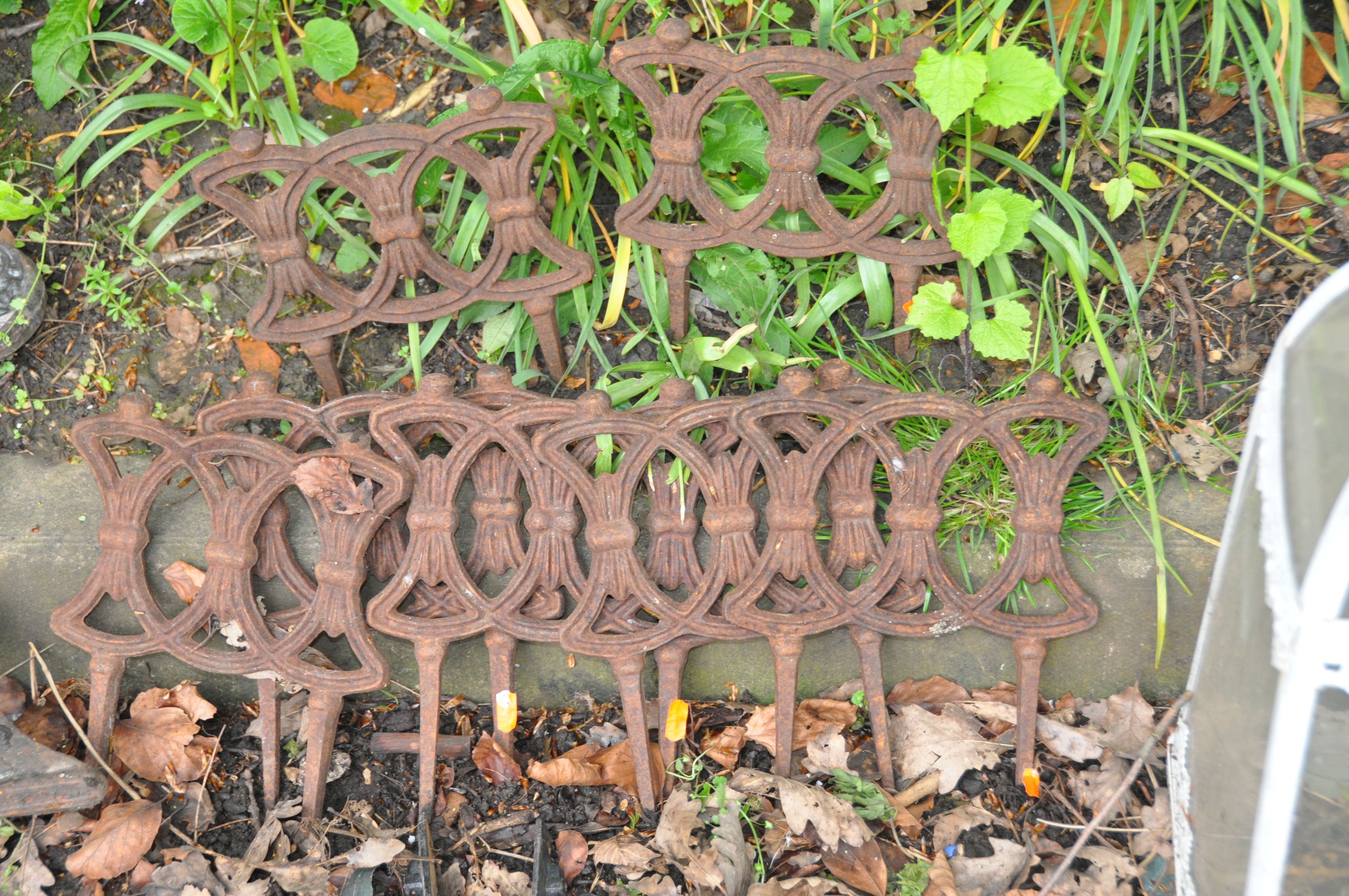 A COLLECTION OF CAST IRON GARDEN ITEMS including seven Victorian lawn edgers, a modern table top, - Image 3 of 6