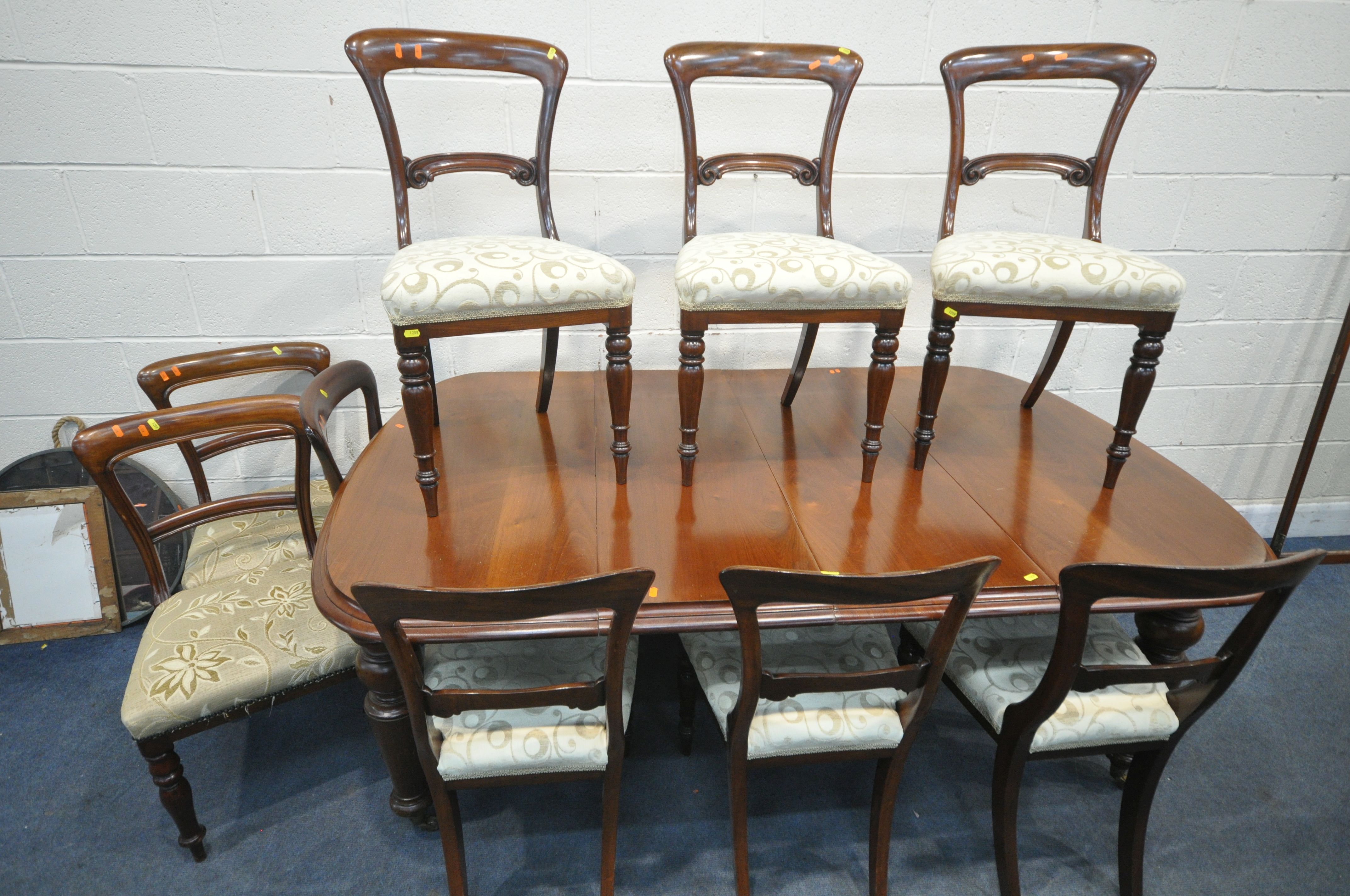 A VICTORIAN STYLE WALNUT WIND OUT DINING TABLE, with two additional leaves, extended length 192cm