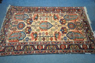 A PERSIAN MALAYER RUG, hand knotted with a repeating stylized pattern on a cream field, and