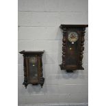 TWO 19TH CENTURY VIENNA WALL CLOCKS, each clock with an arched glass door, that's enclosing an