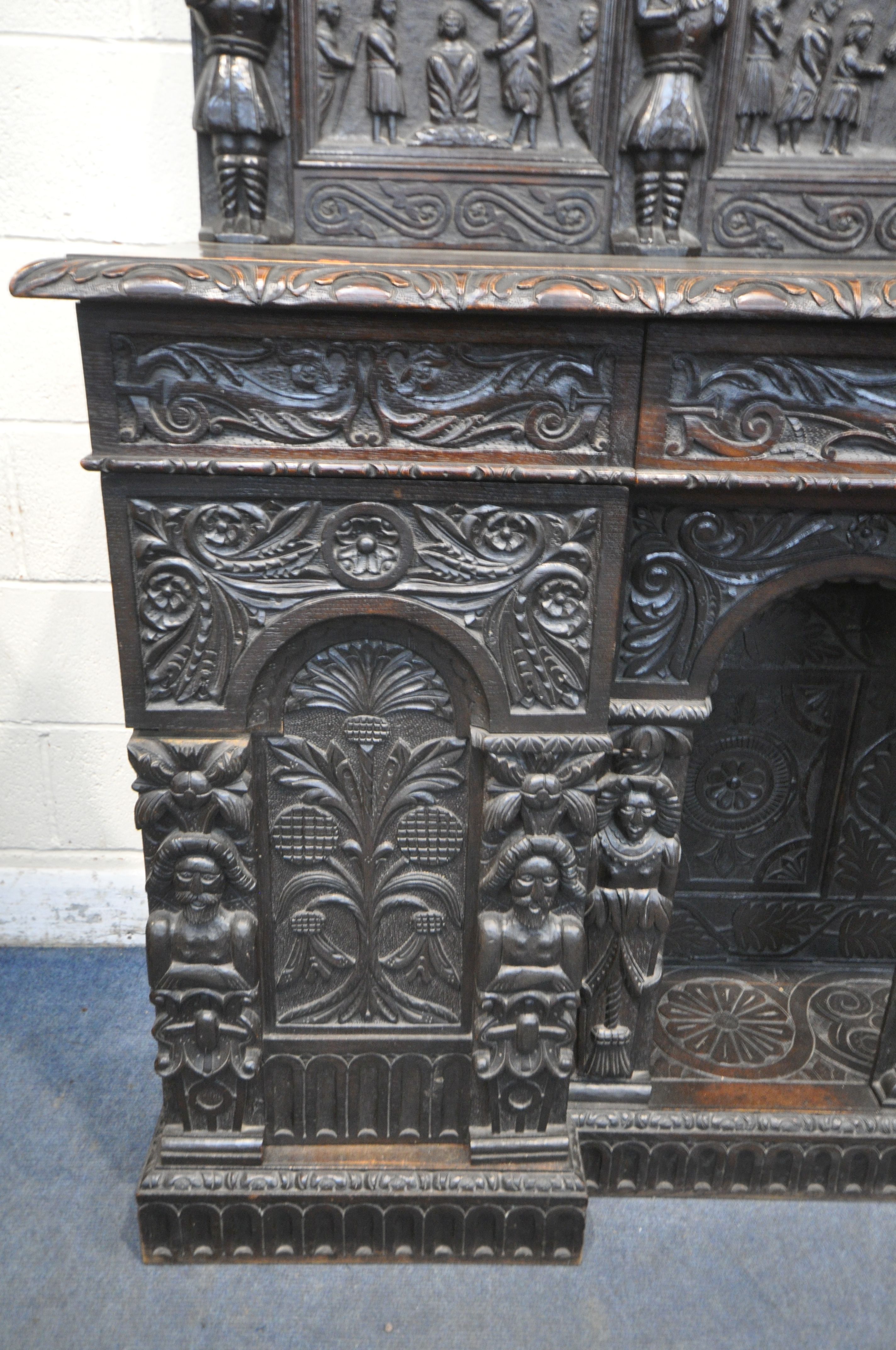 A 19TH CENTURY HEAVILY CARVED OAK SIDEBOARD, the raised back with panelling and shelf, fitted with - Image 5 of 10