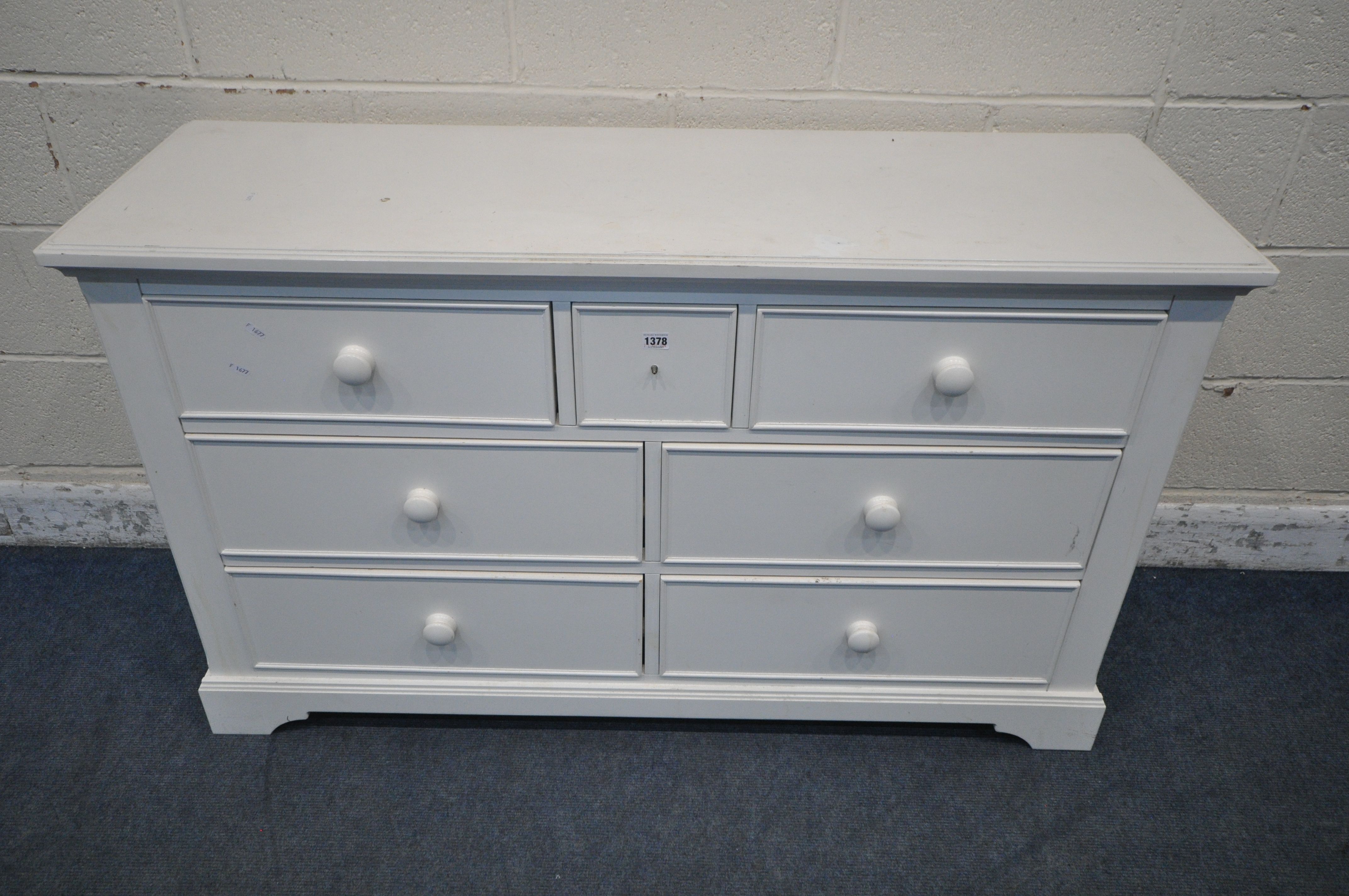 A MODERN WHITE SIDEBOARD, fitted with seven assorted drawers, length 134cm x depth 44cm x height