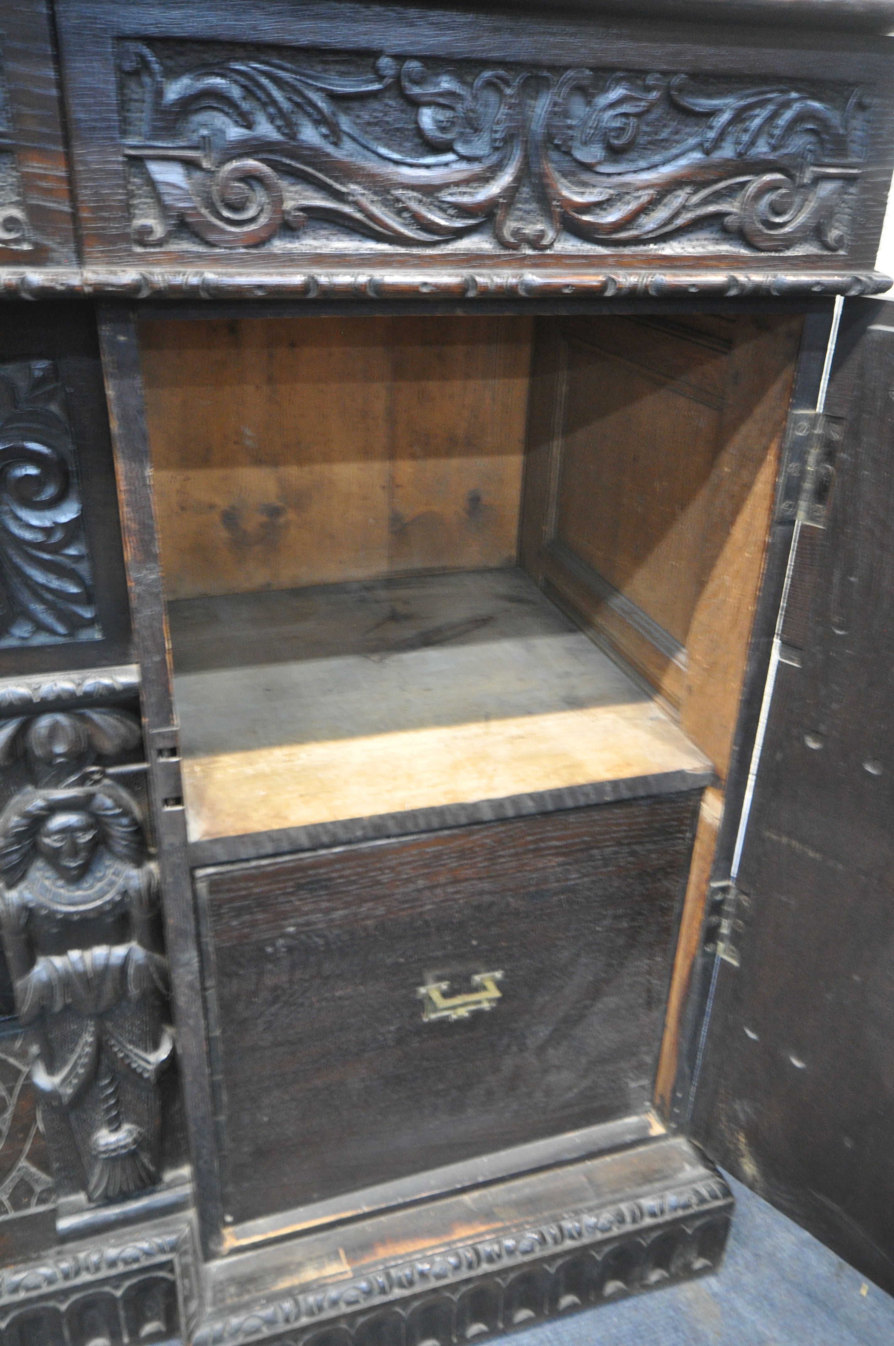 A 19TH CENTURY HEAVILY CARVED OAK SIDEBOARD, the raised back with panelling and shelf, fitted with - Image 8 of 10