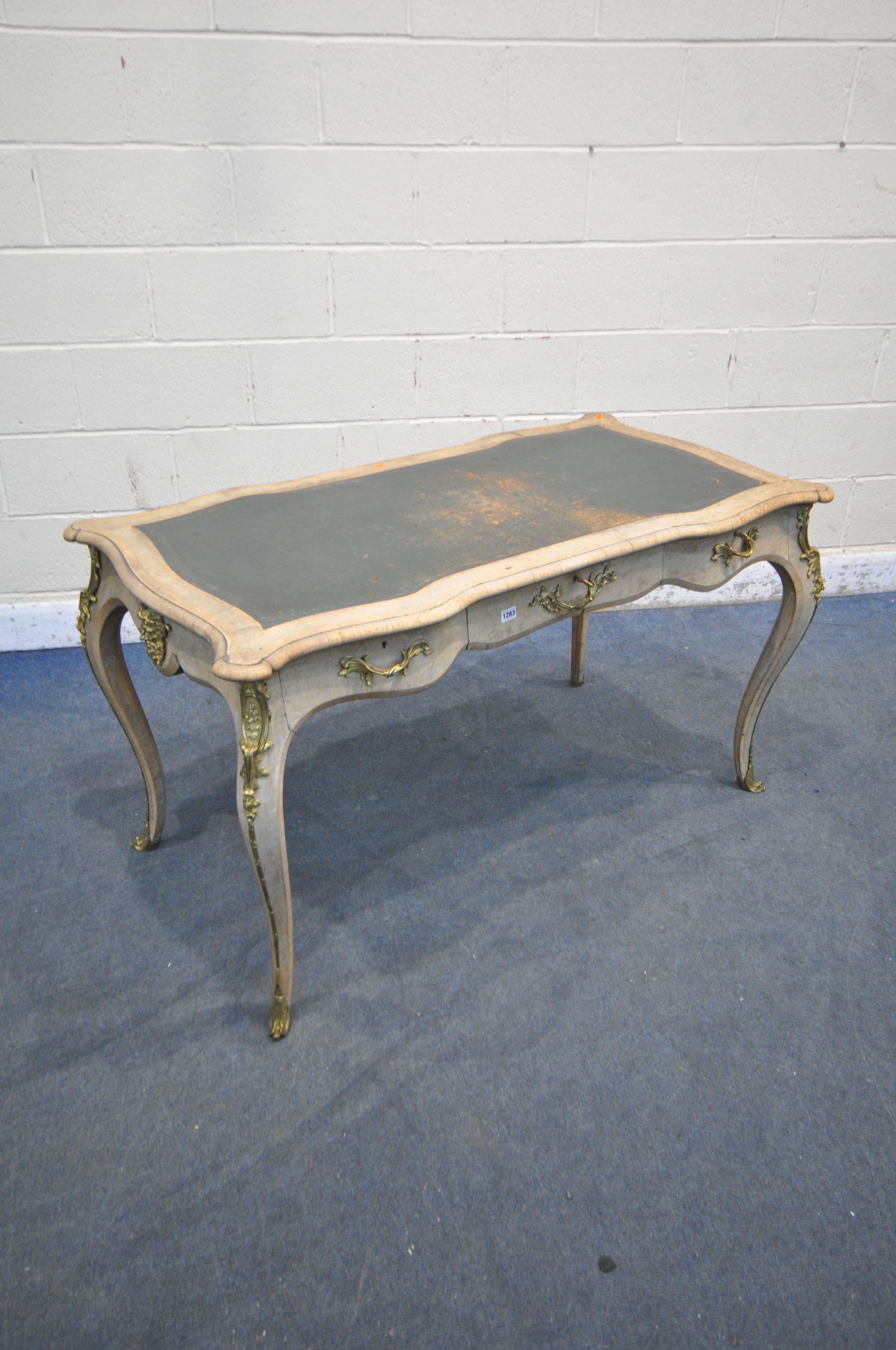 A LOUIS XVI STYLE BURR WALNUT AND CROSSBANDED SERPENTINE WRITING TABLE, green leather writing