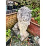 A PAIR OF WEATHERED COMPOSITE SEATED GARDEN LIONS, on a square plinth base, width 35cm x depth