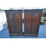 A NEAR PAIR OF VICTORIAN MAHOGANY DOUBLE DOOR WARDROBES, with foliate moulding, one wardrobe