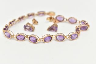 A 14CT GOLD AMETHYST BRACELET AND A PAIR OF 9CT GOLD STUD EARRINGS, the bracelet links designed as