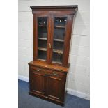 AN EDWARDIAN WALNUT GLAZED BOOKCASE, above a single drawer and double panel doors, width 89cm x