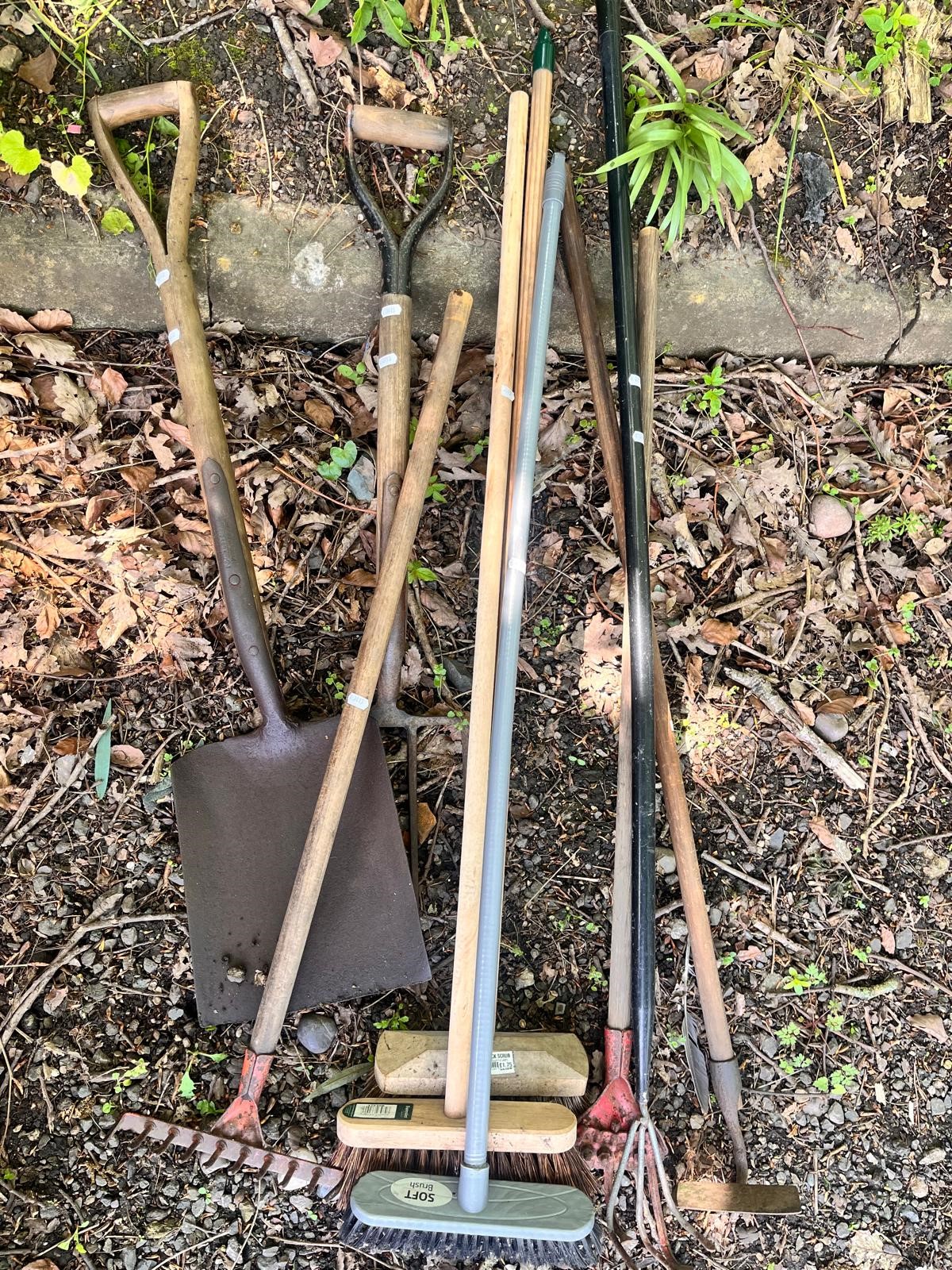 A SELECTION OF GARDEN HAND TOOLS, to include a vintage spade and shovel, three garden brushes, rake,