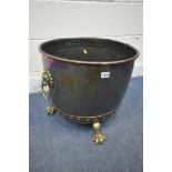 A 19TH CENTURY RIVETED BRASS AND COPPER COAL BUCKET, with lions head handles, and triple paw feet,