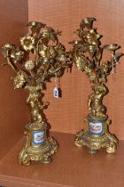 A PAIR OF MID 19TH GILT METAL candelabra, the upper section of floral form fitted with candle