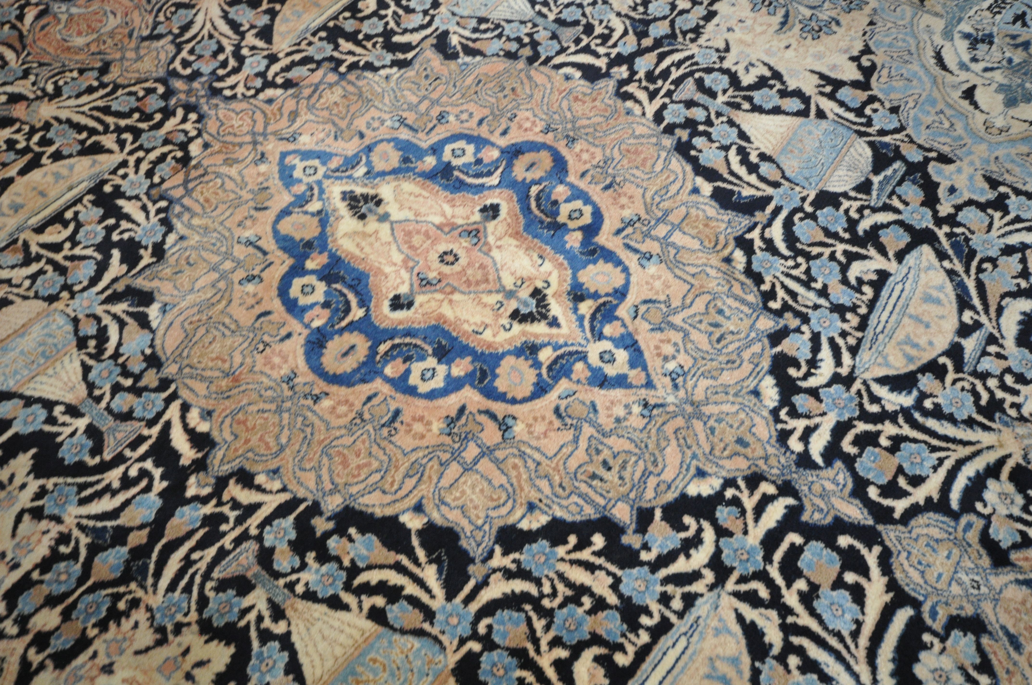 A LARGE WOOLLEN CREAM GROUND RUG, with a repeating foliate pattern, within a dark blue field, and - Image 5 of 6