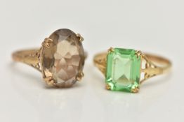 TWO YELLOW METAL GEM SET RINGS, the first set with an oval cut smoky quartz, in a double four claw