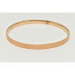 A 9CT GOLD METAL CORE BANGLE, engine turned pattern, stamped '9ct gold solid metal core',