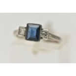 A SAPPHIRE AND DIAMOND RING, designed as a central rectangular cut treated sapphire in milligrain