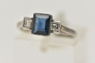 A SAPPHIRE AND DIAMOND RING, designed as a central rectangular cut treated sapphire in milligrain