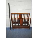 AN EARLY 20TH CENTURY MAHOGANY 4FT6 BEDSTEAD, with cast iron side rails (condition report: general