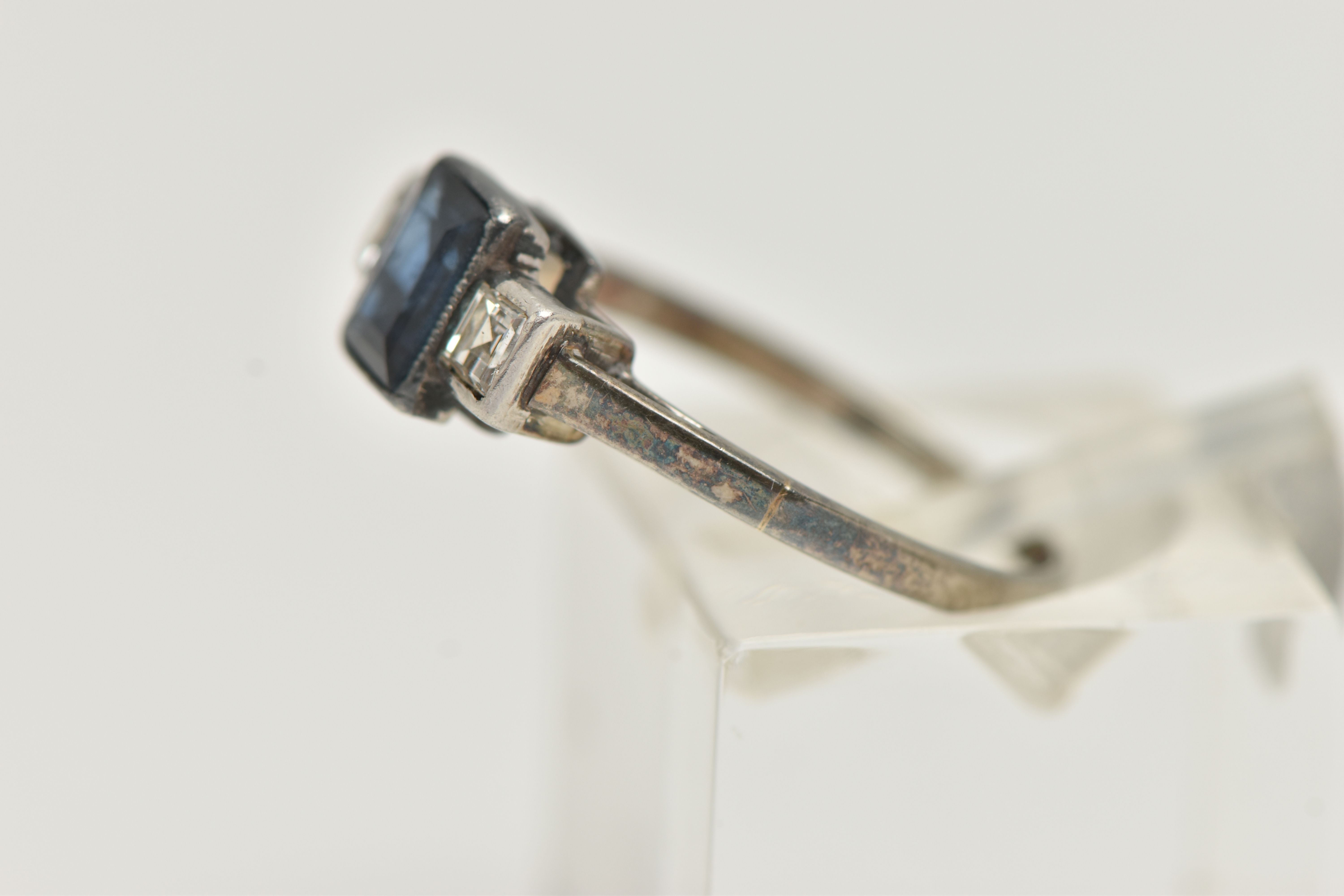 A SAPPHIRE AND DIAMOND RING, designed as a central rectangular cut treated sapphire in milligrain - Image 2 of 4