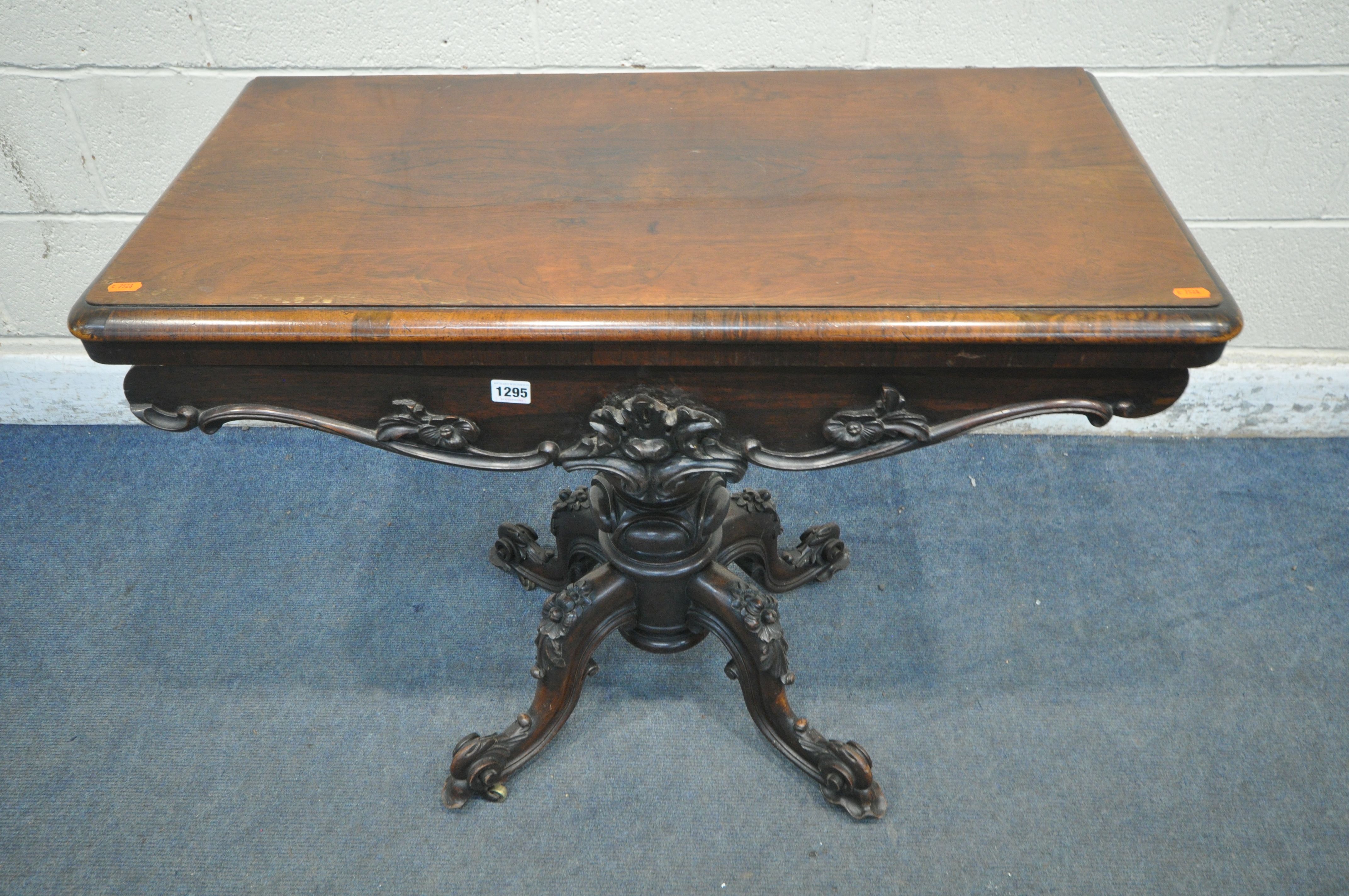 A VICTORIAN ROSEWOOD CARD TABLE, the twist and fold top enclosing a circular green baize playing