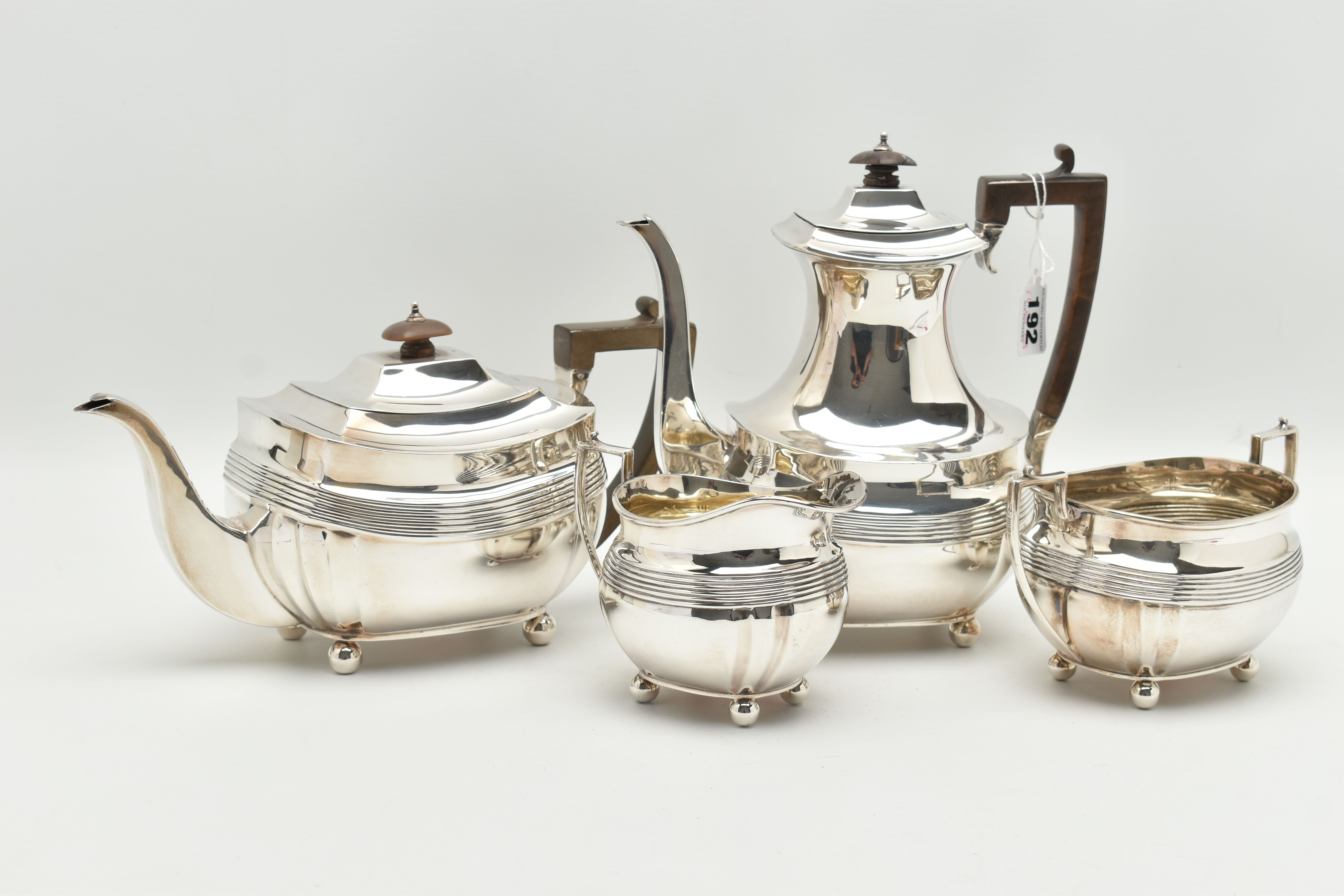 A GEORGE V SILVER FOUR PIECE TEA SERVICE OF SHAPED RECTANGULAR FORM, reeded horizonal band detail