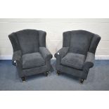 A PAIR OF DARK BLUE UPHOLSTERED ARMCHAIRS, along with a brown footstool (condition report: in need