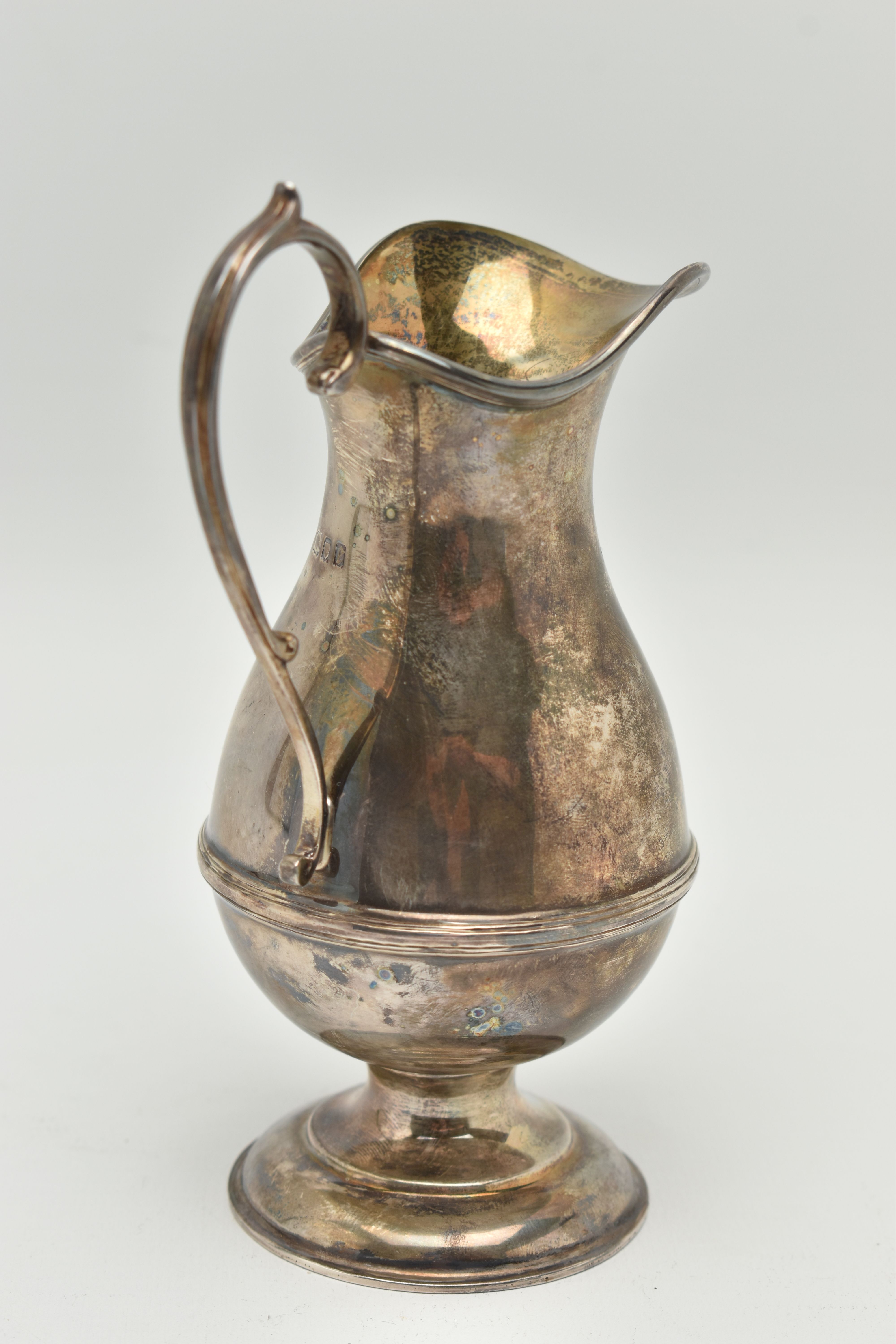 A GEORGE V SILVER CREAM JUG, a baluster form jug with a scrolling handle, approximate height - Image 3 of 5