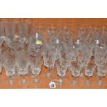 A COLLECTION OF ASSORTED DRINKING GLASSES. including a set of twelve champagne flutes, a set of