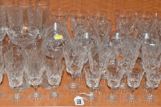 A COLLECTION OF ASSORTED DRINKING GLASSES. including a set of twelve champagne flutes, a set of