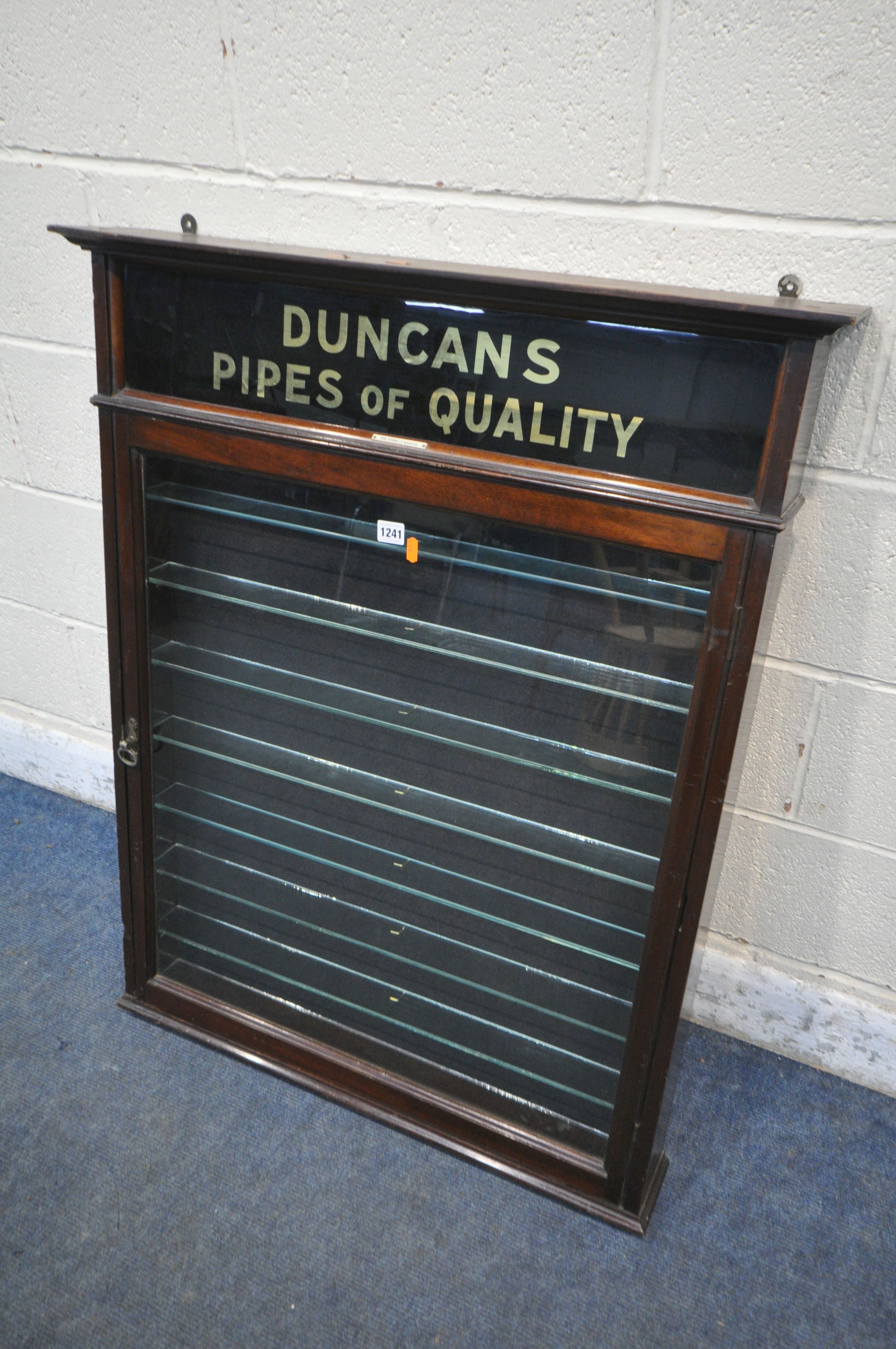 AN EARLY 20TH CENTURY MAHOGANY SINGLE DOOR DUNCAN'S PIPES OF QUALITY DISPLAY CASE, enclosing seven